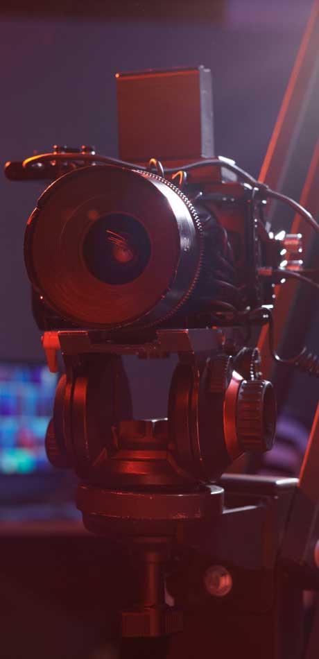 Large professional video camera rolling in a studio during a live recording session.