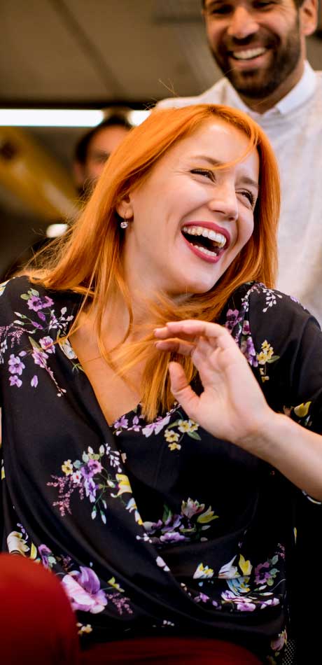 Smiling and laughing customer enjoying a live event streamed and produced by VYB STUDIOS.